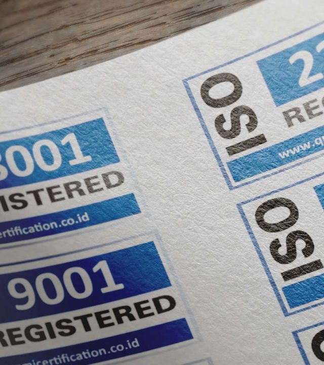 ISO certification stickers with registration numbers on paper.